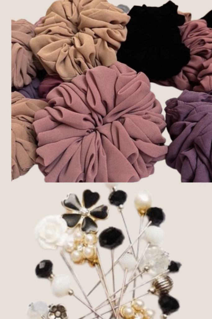 Collection of fabric scrunchies in neutral and pastel shades placed together, above a set of decorative hijab pins with pearl, floral, and gemstone designs
