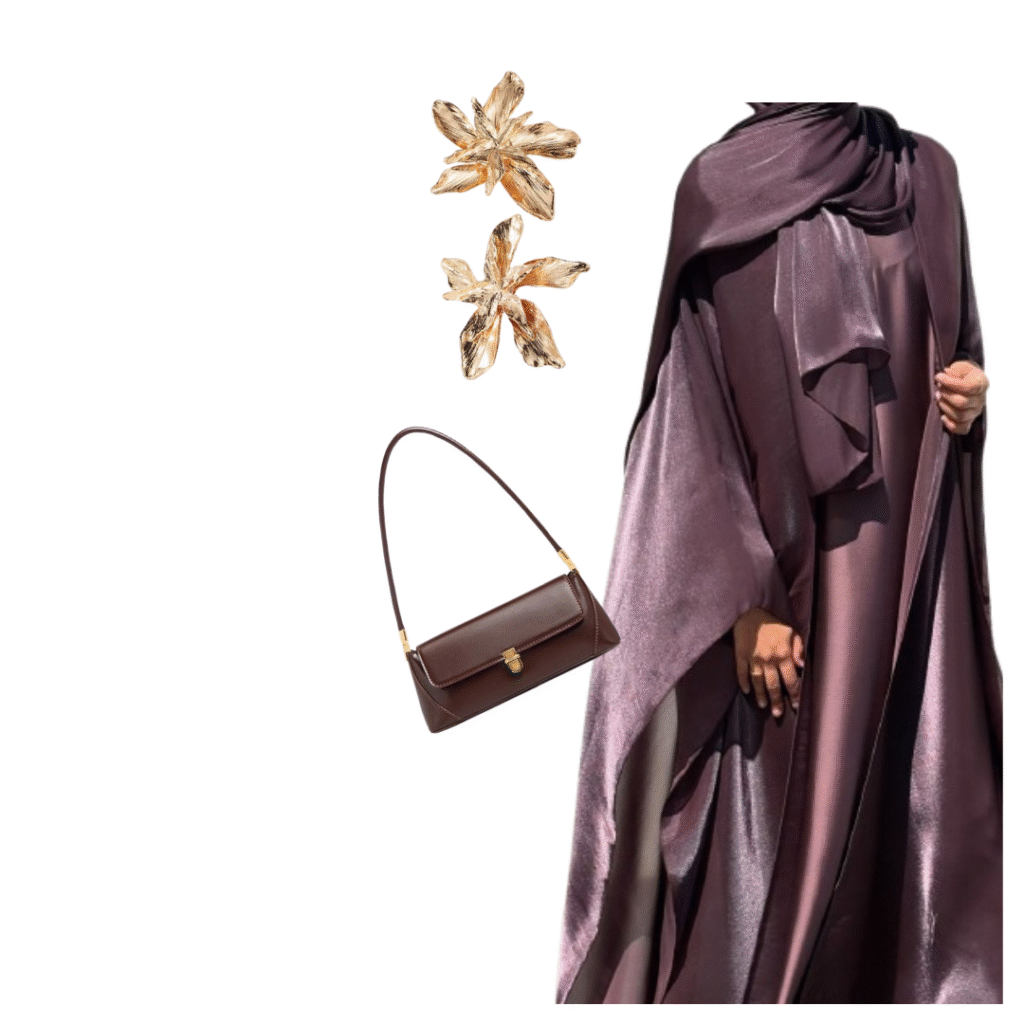 A stylish outfit featuring a shiny plum-colored abaya, gold flower-shaped earrings, and a dark brown shoulder bag.