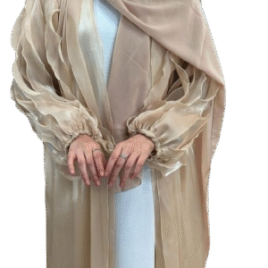 a sheer, shimmering beige or champagne abaya with large, layered ruffles on the sleeves, paired with a matching nude hijab