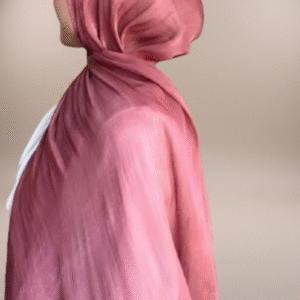 wearing a shimmery, dusty rose-colored hijab against a soft, neutral, light