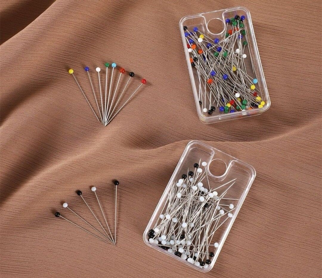 plastic cases filled with dressmaker