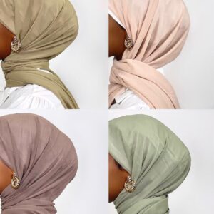 wearing a soft, draped, sand-colored jersey knit hijab, secured with a large, textured gold knot earring visible on the side.